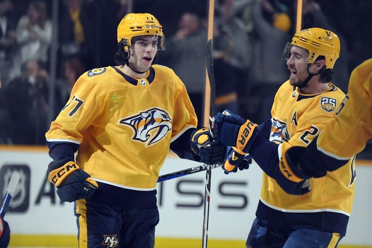Jan 13, 2024; Nashville, Tennessee, USA; Nashville Predators right wing Luke Evangelista (77) celebrates with /defenseman Ryan McDonagh (27) after scoring during the third period against the New York Islanders at Bridgestone Arena.