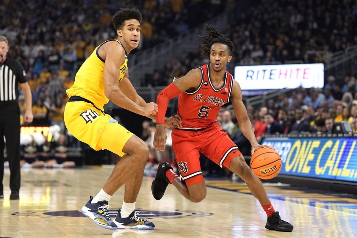 Feb 10, 2024; Milwaukee, Wisconsin, USA;  St. John's Red Storm guard Daniss Jenkins (5) drives for the basket against Marquette Golden Eagles forward Oso Ighodaro (13) during the first half at Fiserv Forum.