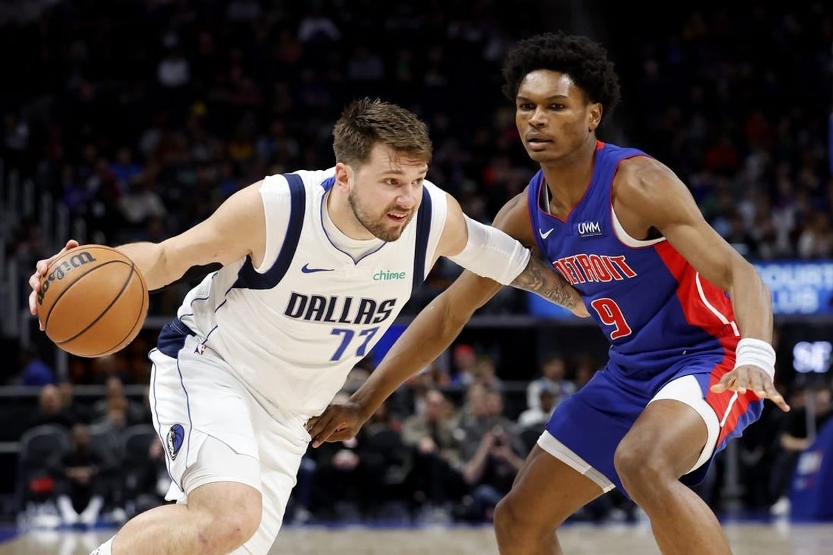 Mar 9, 2024; Detroit, Michigan, USA;  Dallas Mavericks guard Luka Doncic (77) dribbles against Detroit Pistons forward Ausar Thompson (9) in the first half at Little Caesars Arena.
