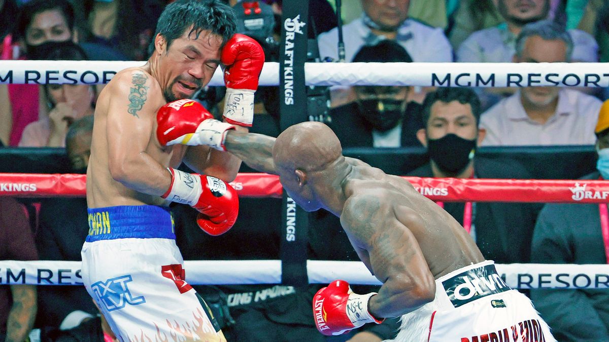 Yordenis Ugas throws a right at Manny Pacquiao in the fifth round of their WBA welterweight title fight at T-Mobile Arena on August 21, 2021 in Las Vegas, Nevada.