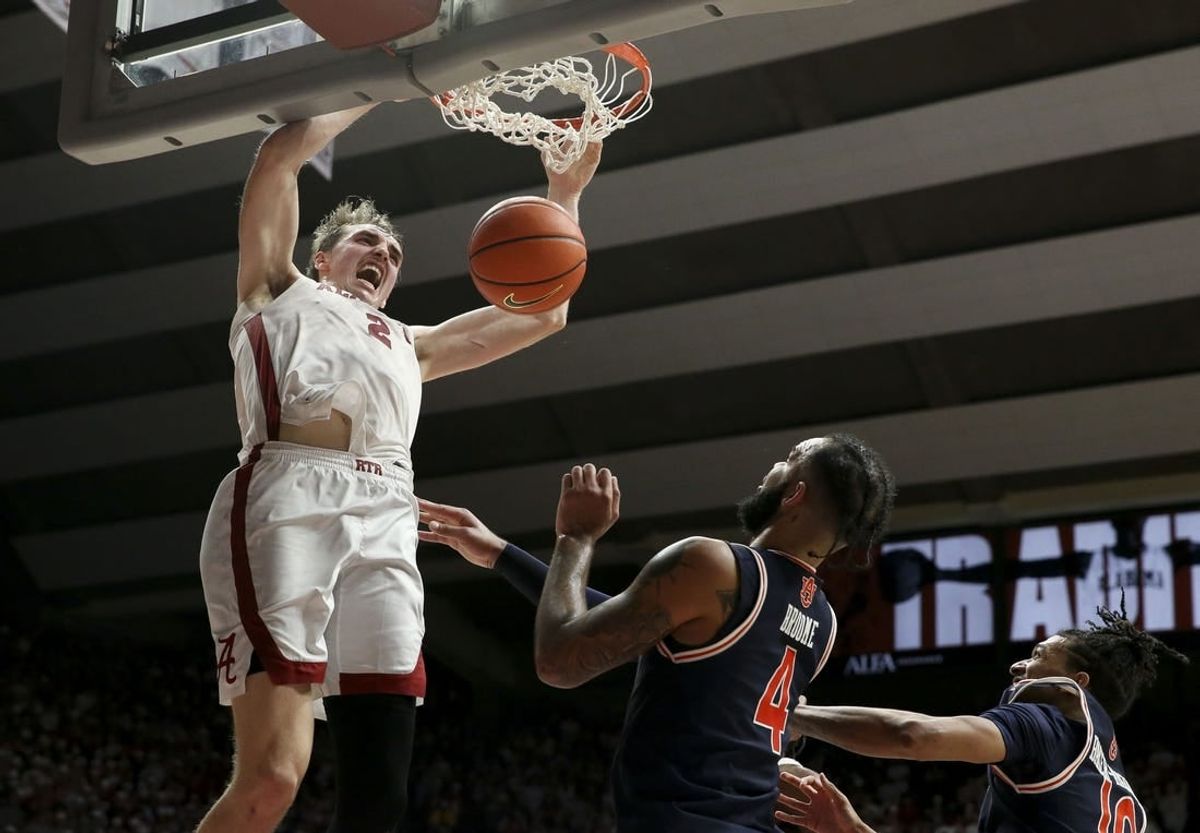 Jan 24, 2024; Tuscaloosa, Alabama, USA; Alabama Crimson Tide forward Grant Nelson (2) makes a dunk late in the game over Auburn Tigers center Johni Broome (4) at Coleman Coliseum.