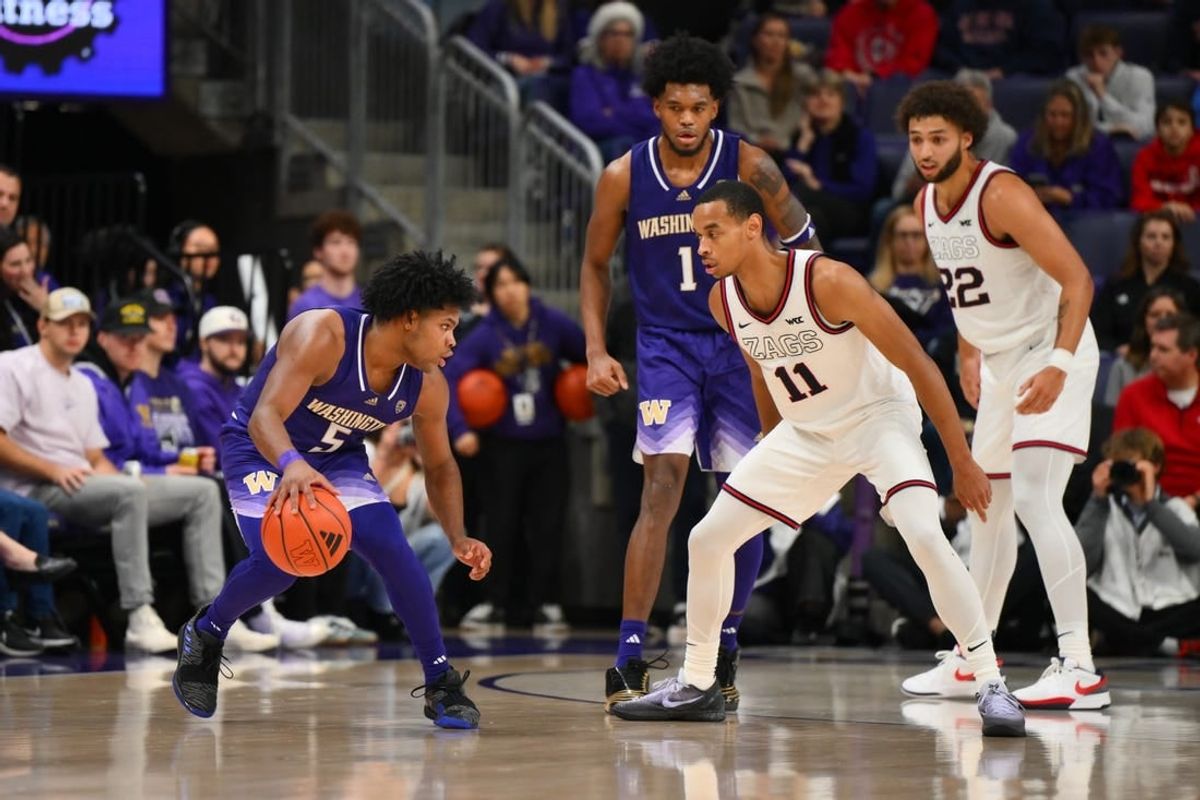 Dec 9, 2023; Seattle, Washington, USA; Gonzaga Bulldogs guard Nolan Hickman (11) guards Washington Huskies guard Sahvir Wheeler (5) during the second half at Alaska Airlines Arena at Hec Edmundson Pavilion.