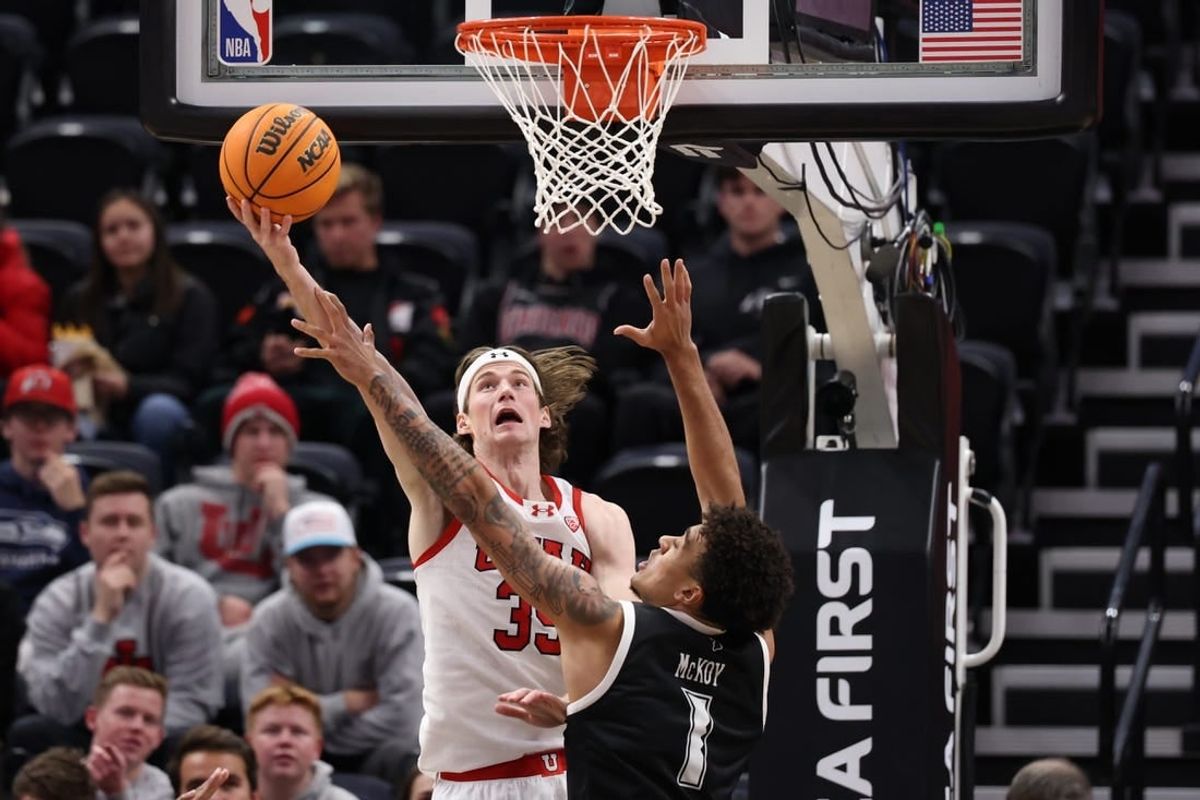 Nov 30, 2023; Salt Lake City, Utah, USA; Utah Utes center Branden Carlson (35) shoots the ball over Hawaii Warriors forward Justin McKoy (1) during the first half at Delta Center.