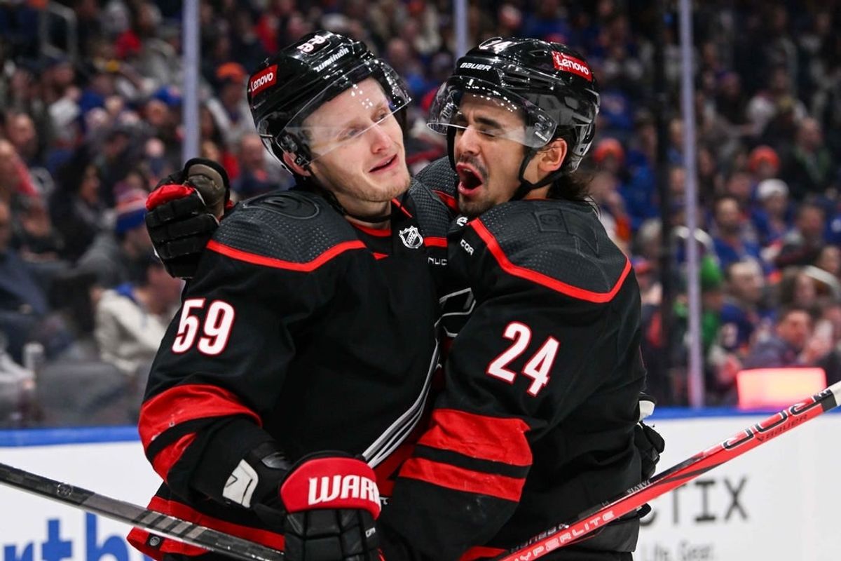 Mar 19, 2024; Elmont, New York, USA; Carolina Hurricanes center Seth Jarvis (24) celebrates his second goal against the New York Islanders with Carolina Hurricanes left wing Jake Guentzel (59) during the first period at UBS Arena.