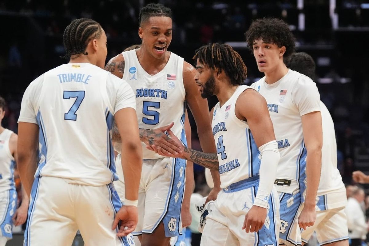 Mar 23, 2024; Charlotte, NC, USA;  North Carolina Tar Heels forward Armando Bacot (5) congratulates guard RJ Davis (4) after hitting a three point shot against Michigan State Spartans at Spectrum Center.