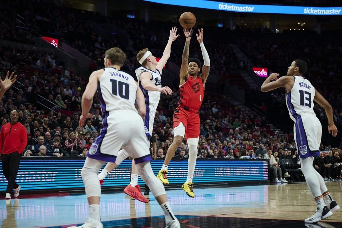 Dec 26, 2023; Portland, Oregon, USA; Portland Trail Blazers guard Anfernee Simons (1) shoots a jump shot against Sacramento Kings guard Kevin Huerter (9) during the first half at Moda Center.