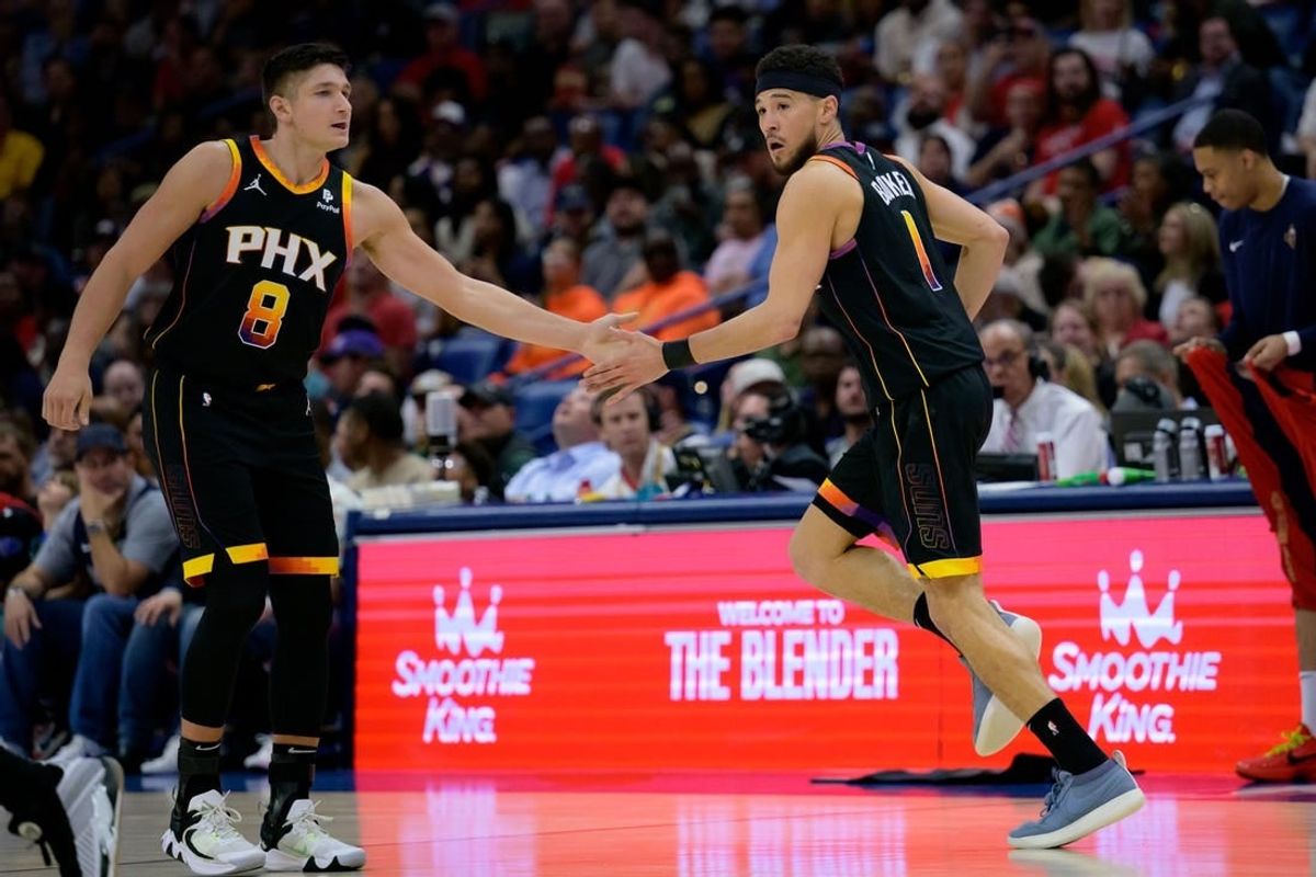 Apr 1, 2024; New Orleans, Louisiana, USA; Phoenix Suns guard Devin Booker (1) celebrates with Phoenix Suns guard Grayson Allen (8) against the New Orleans Pelicans during the first half at Smoothie King Center.