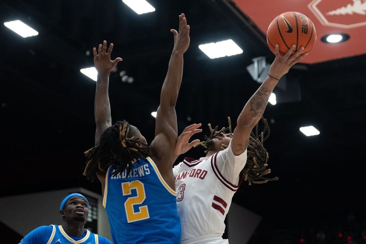 Feb 7, 2024; Stanford, California, USA; Stanford Cardinal guard Andrej Stojakovic (2) attempts to shoot over UCLA Bruins guard Dylan Andrews (2) during the first half at Maples Pavilion.