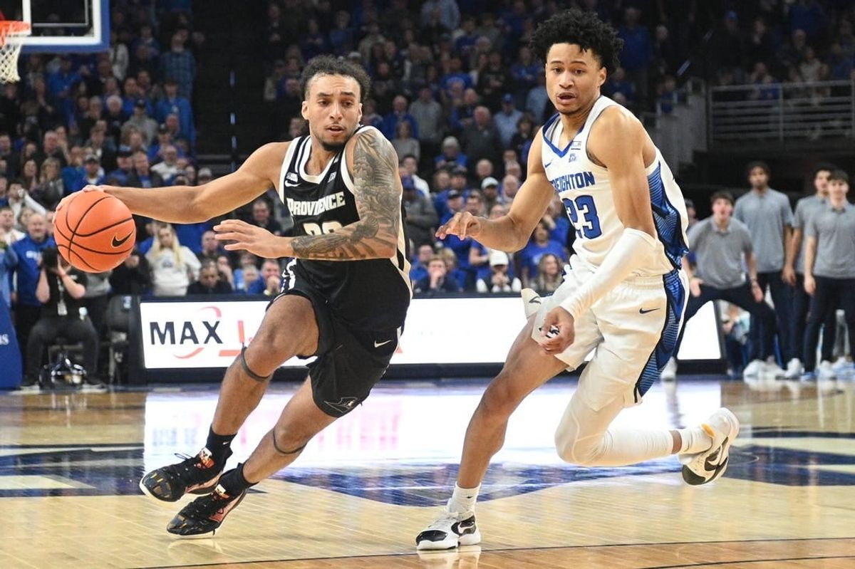 Jan 6, 2024; Omaha, Nebraska, USA; Providence Friars guard Devin Carter (22) drives against Creighton Bluejays guard Trey Alexander (23) in the second half at CHI Health Center Omaha.
