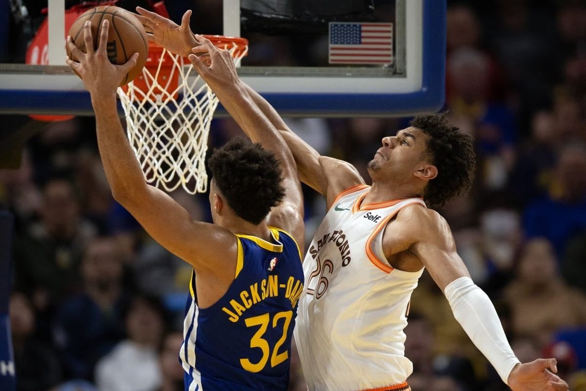 Mar 9, 2024; San Francisco, California, USA; Golden State Warriors forward Trayce Jackson-Davis (32) manages to get a shot around the defense of San Antonio Spurs forward Dominick Barlow (26) during the third quarter at Chase Center.