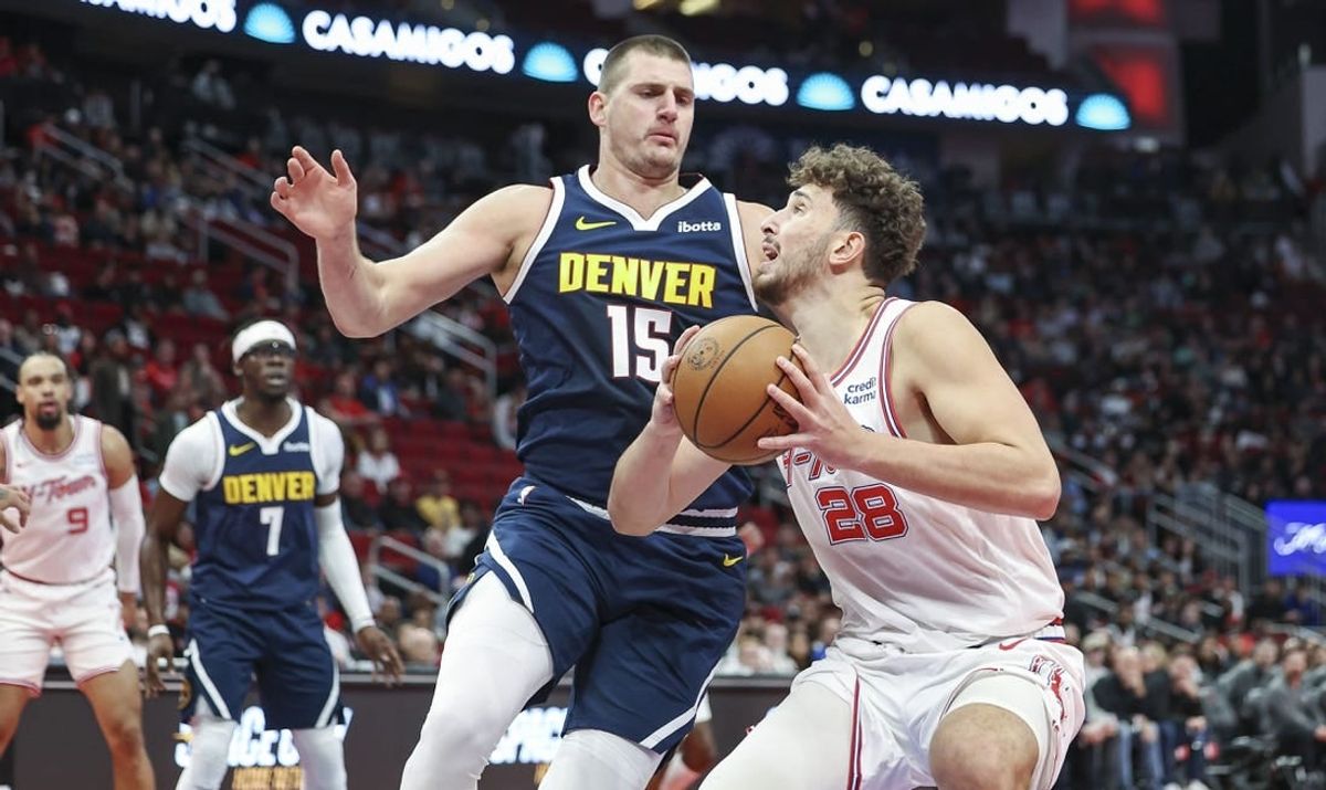 Nov 24, 2023; Houston, Texas, USA; Houston Rockets center Alperen Sengun (28) drives with the ball as Denver Nuggets center Nikola Jokic (15) defends during the first quarter at Toyota Center.