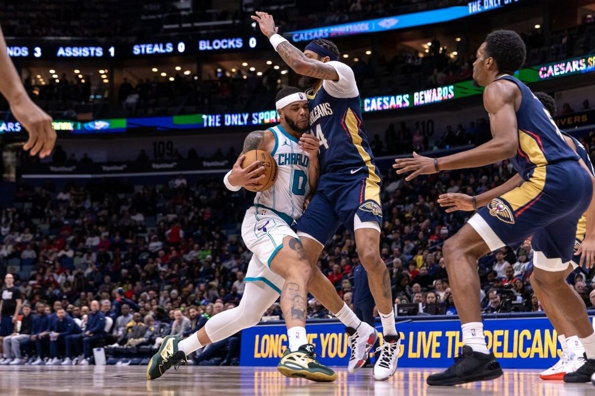 Jan 17, 2024; New Orleans, Louisiana, USA; Charlotte Hornets forward Miles Bridges (0) dribbles against New Orleans Pelicans forward Brandon Ingram (14) during the second half at Smoothie King Center.