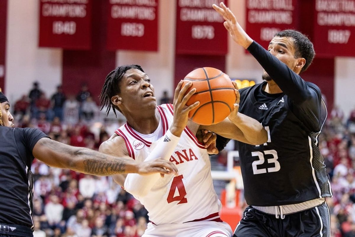 Dec 21, 2023; Bloomington, Indiana, USA; Indiana Hoosiers forward Anthony Walker (4) dribbles the ball as North Alabama Lions forward Tim Smith Jr. (23) defends in the first half at Simon Skjodt Assembly Hall.