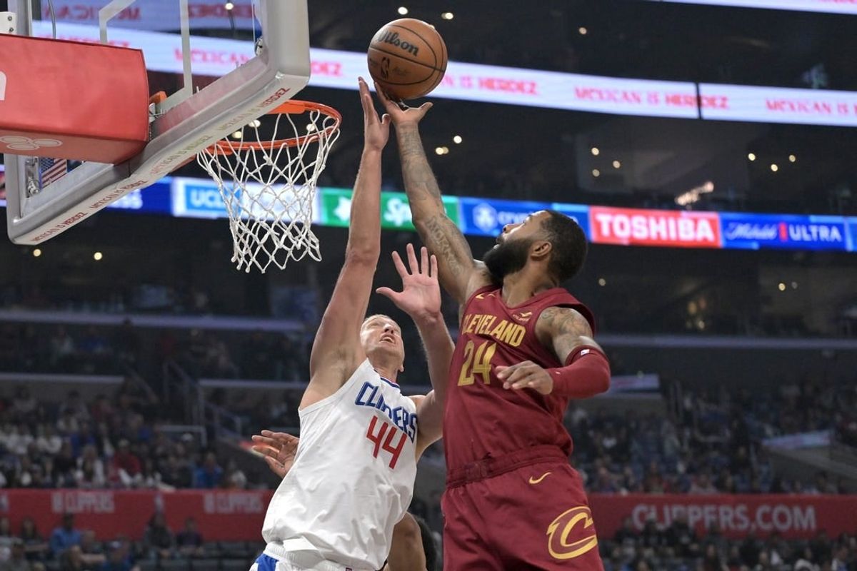 Apr 7, 2024; Los Angeles, California, USA; Cleveland Cavaliers forward Marcus Morris Sr. (24) reaches in front of Los Angeles Clippers center Mason Plumlee (44) to steal a pass in the first half at Crypto.com Arena.