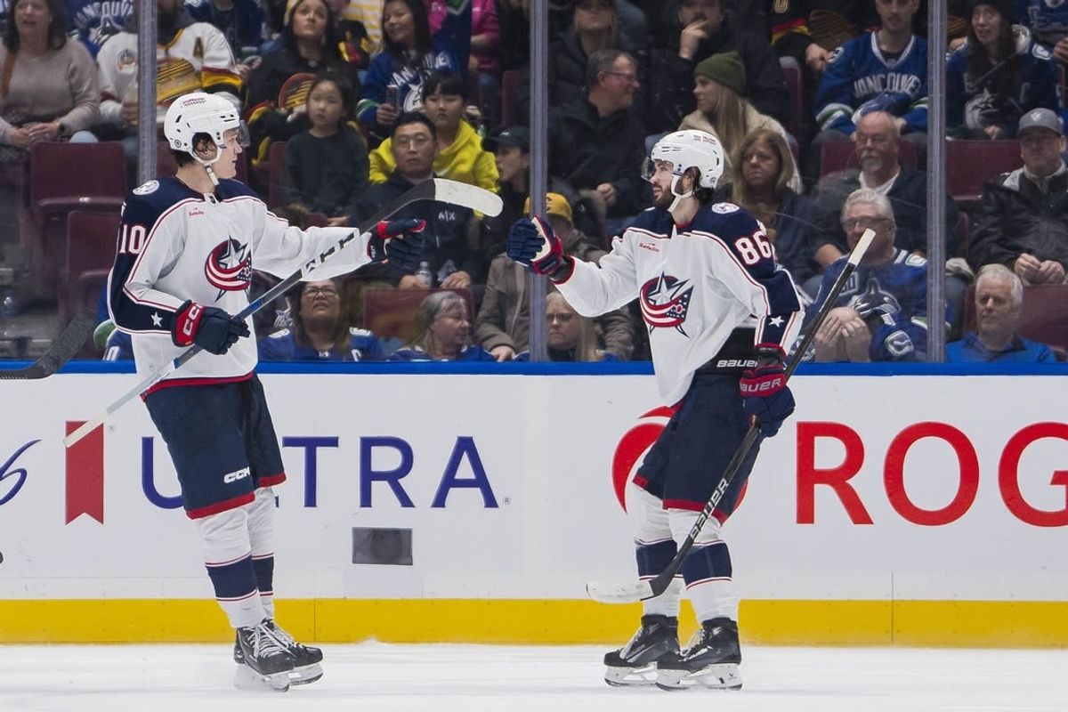 Jan 27, 2024; Vancouver, British Columbia, CAN; Columbus Blue Jackets forward Dmitri Voronkov (10) and forward Kirill Marchenko (86) celebrate Marchenko   s goal against the Vancouver Canucks in the second period at Rogers Arena.