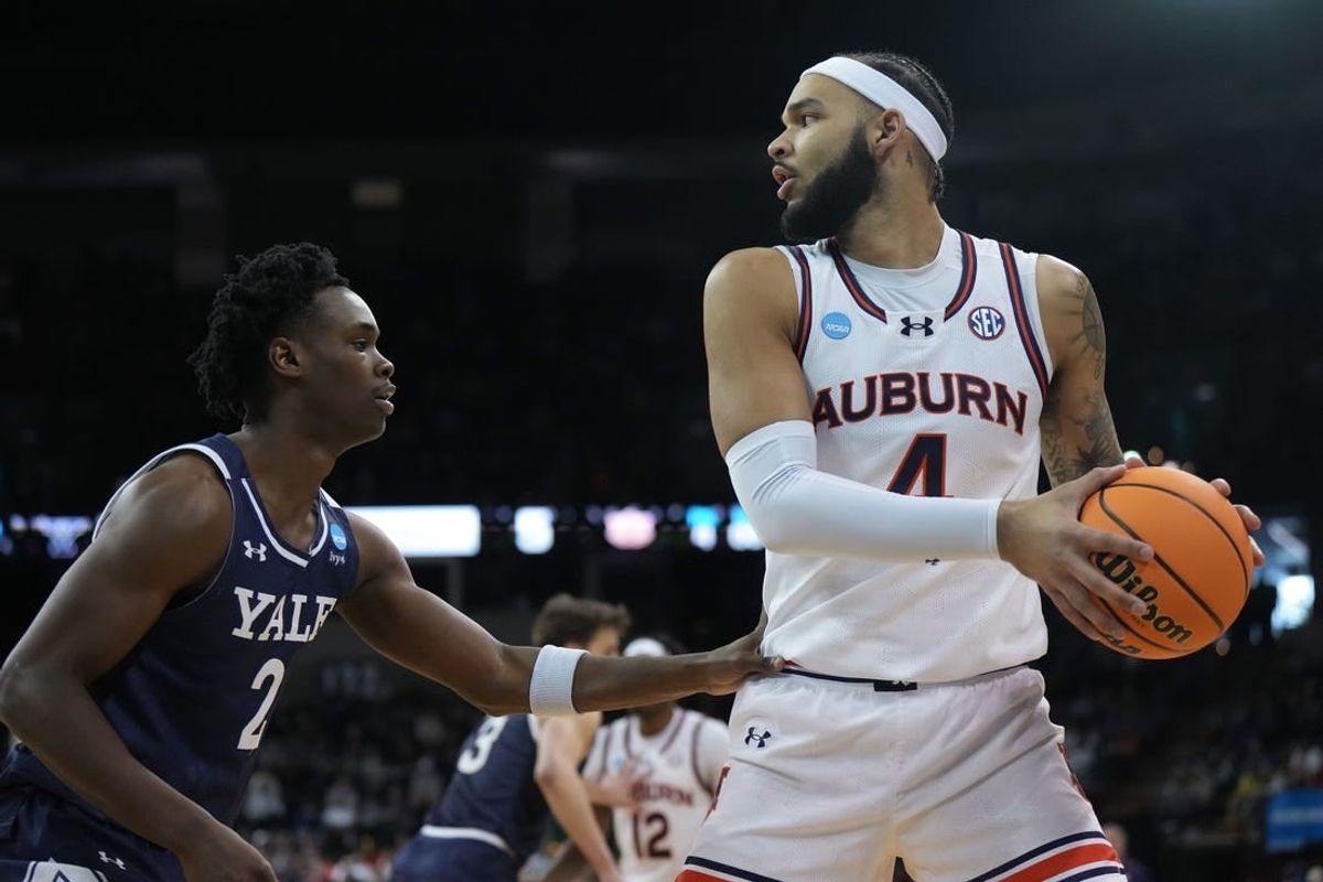 Mar 22, 2024; Spokane, WA, USA; Auburn Tigers forward Johni Broome (4) drives to the basket against Yale Bulldogs guard Bez Mbeng (2) during the first half of a game in the first round of the 2024 NCAA Tournament at Spokane Veterans Memorial Arena.
