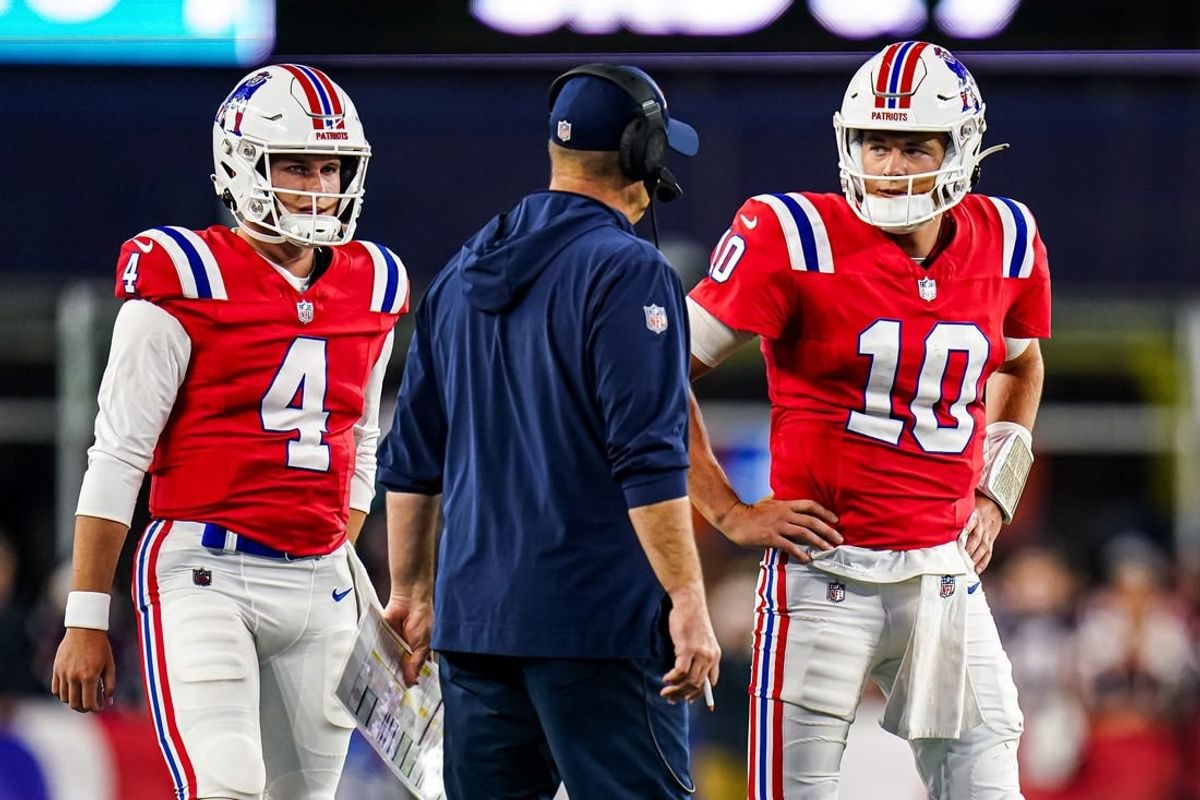 Sep 17, 2023; Foxborough, Massachusetts, USA; New England Patriots quarterback Mac Jones (10) and quarterback Bailey Zappe (4) talk with offensive coordinator/quarterbacks coach Bill O'Brien in the second quarter at Gillette Stadium.