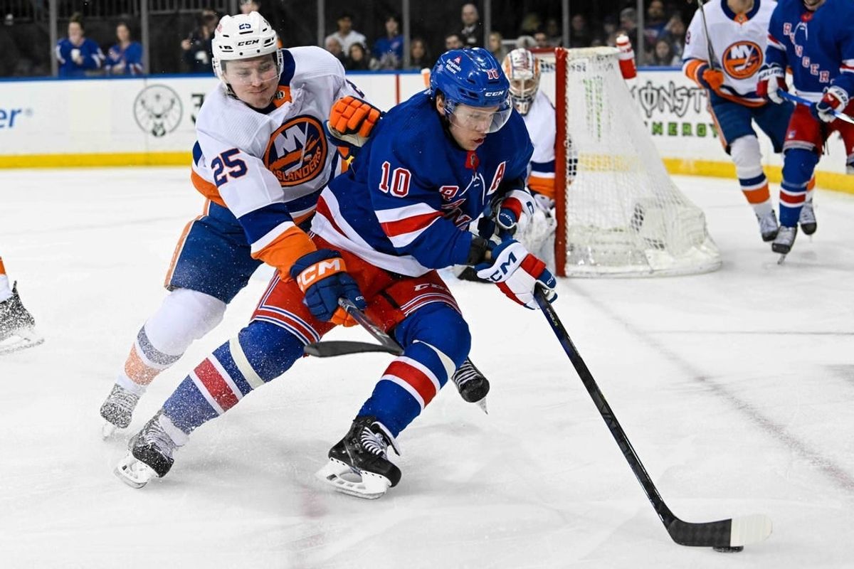Apr 13, 2024; New York, New York, USA;  New York Rangers left wing Artemi Panarin (10) controls the puck defended by New York Islanders defenseman Sebastian Aho (25) during the second period at Madison Square Garden.
