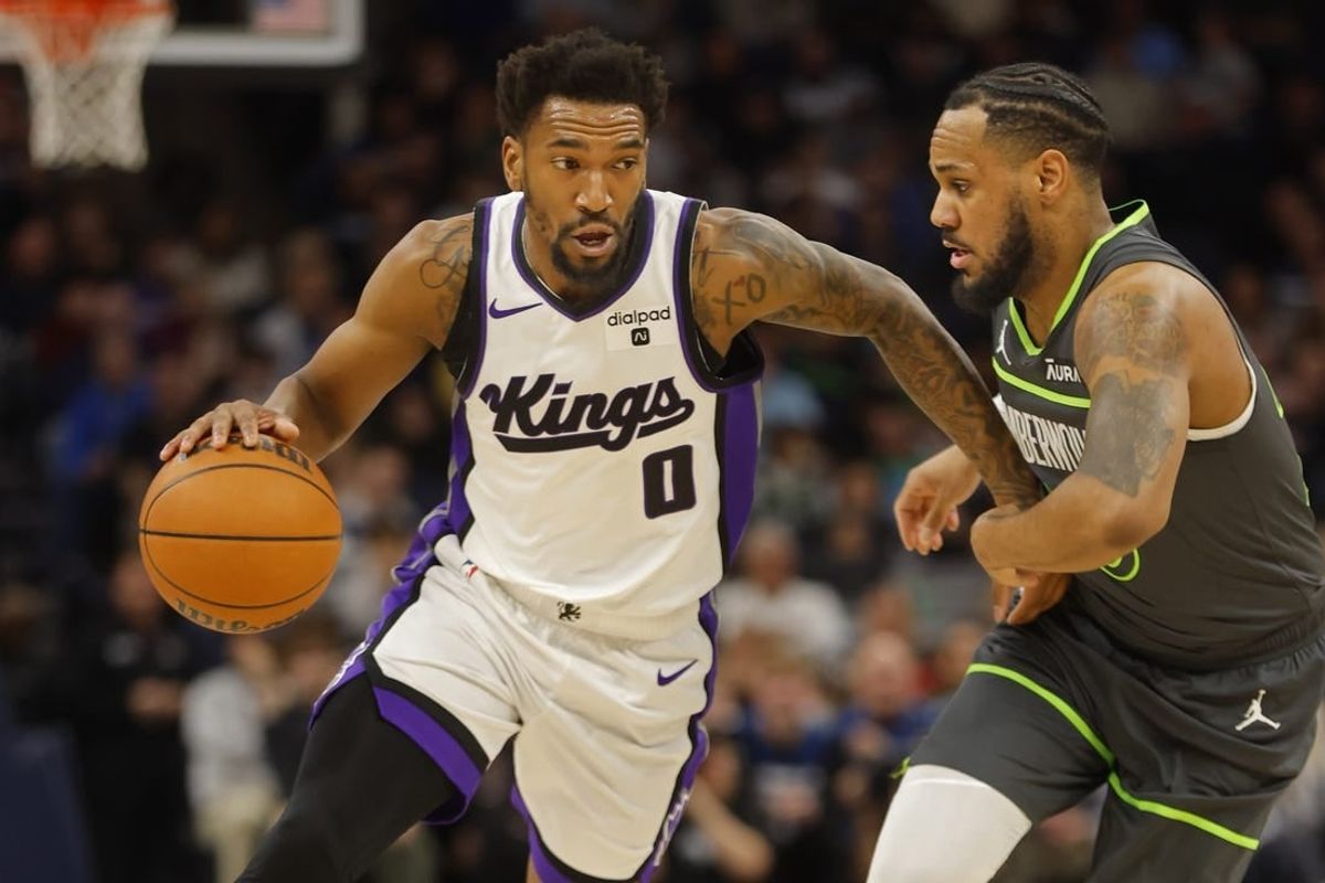 Mar 1, 2024; Minneapolis, Minnesota, USA; Sacramento Kings guard Malik Monk (0) works around Minnesota Timberwolves guard Monte Morris (23) in the first quarter at Target Center.