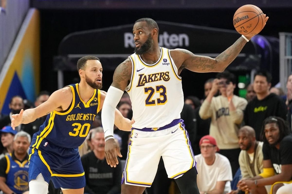 Jan 27, 2024; San Francisco, California, USA; Golden State Warriors forward Draymond Green (23) handles the ball against Golden State Warriors guard Stephen Curry (30) during overtime at Chase Center.