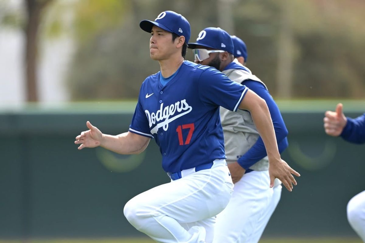 Feb 18, 2024; Glendale, AZ, USA;  Los Angeles Dodgers designated hitter Shohei Ohtani (17) stretches during spring training at Camelback Ranch.