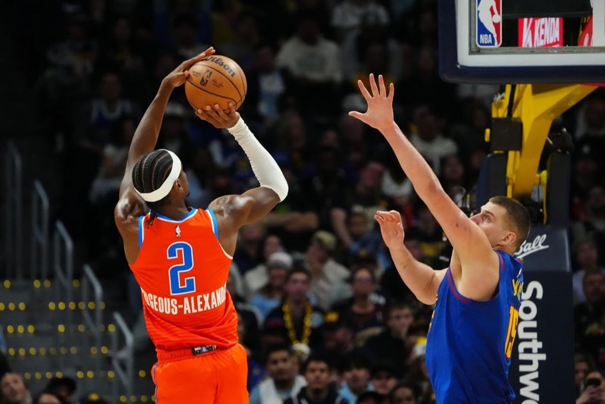 Dec 16, 2023; Denver, Colorado, USA; Oklahoma City Thunder guard Shai Gilgeous-Alexander (2) shoots the ball over Denver Nuggets center Nikola Jokic (15) in the fourth quarter at Ball Arena.