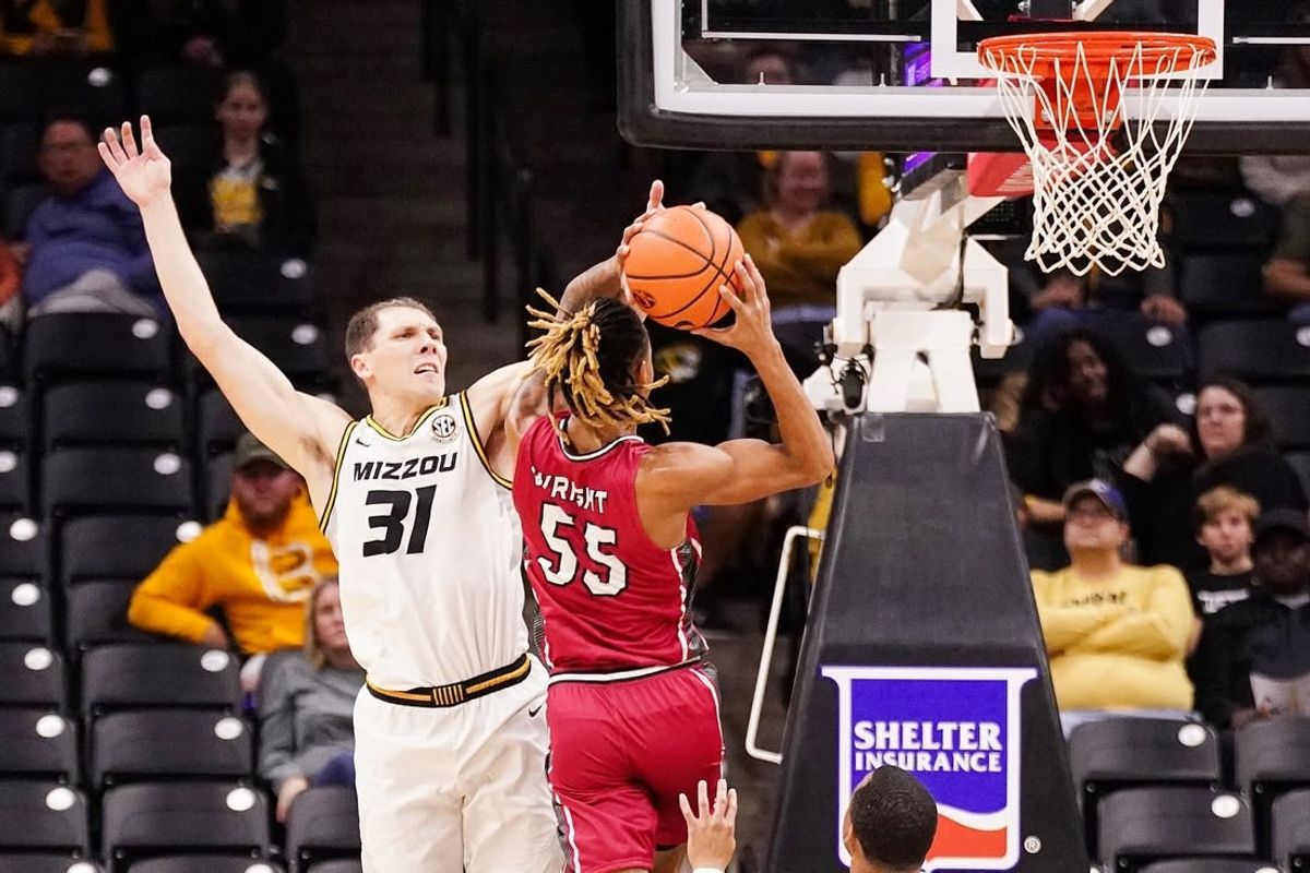 Nov 13, 2023; Columbia, Missouri, USA; SIU Edwardsville Cougars forward Lamar Wright (55) shoots as Missouri Tigers guard Caleb Grill (31) defends during the first half at Mizzou Arena.