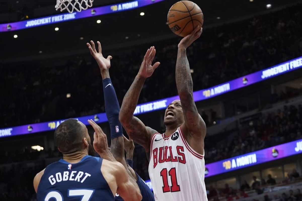 Feb 6, 2024; Chicago, Illinois, USA; Minnesota Timberwolves center Rudy Gobert (27) defends Chicago Bulls forward DeMar DeRozan (11) during the first quarter at United Center.