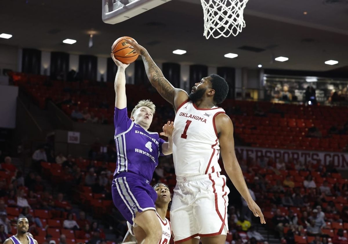 Dec 28, 2023; Norman, Oklahoma, USA; Central Arkansas Bears guard Johannes Kirsipuu (4) shoots as Oklahoma Sooners forward John Hugley IV (1) defends during the first half at Lloyd Noble Center.
