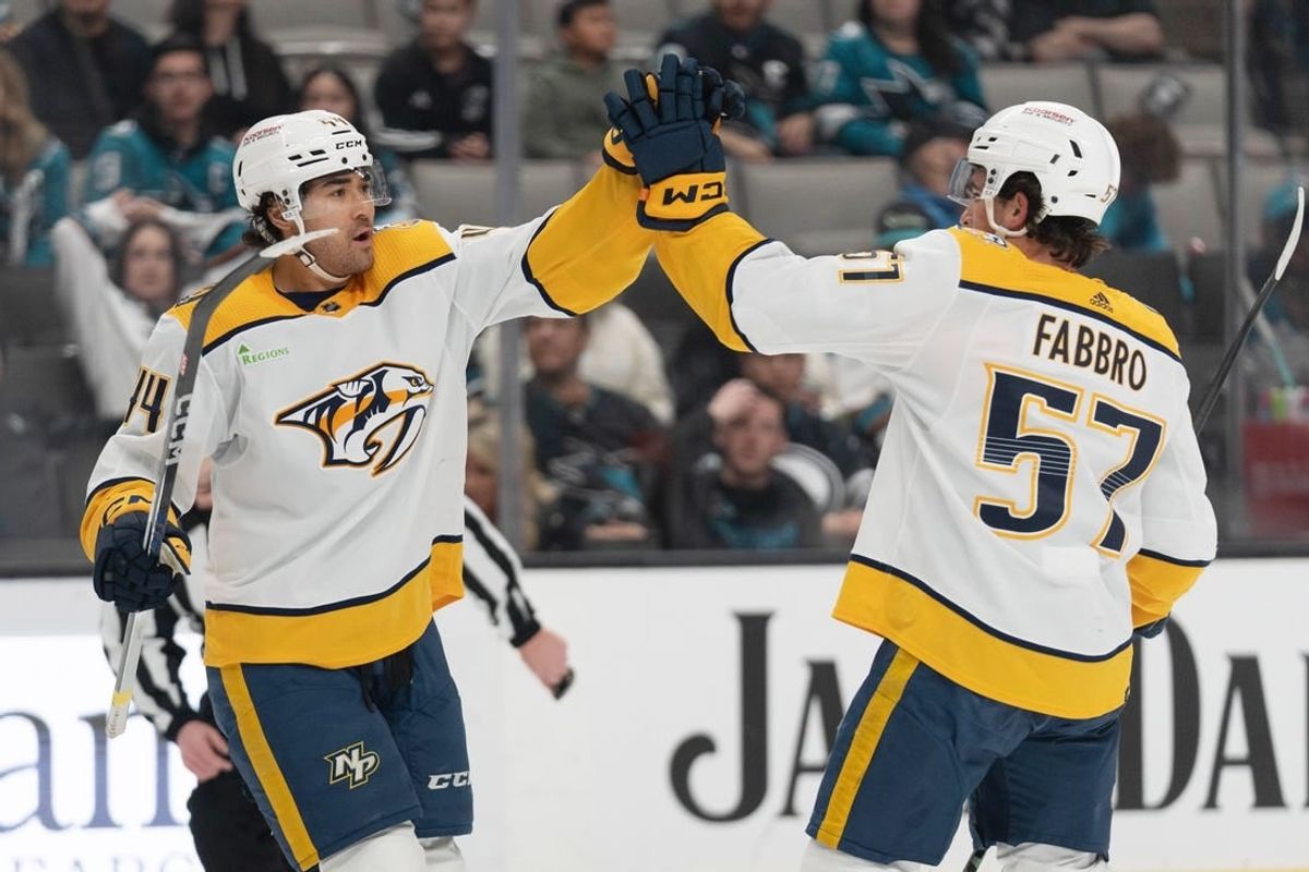 Feb 24, 2024; San Jose, California, USA; Nashville Predators left wing Kiefer Sherwood (44) celebrates with defenseman Dante Fabbro (57) after scoring a goal during the first period against the San Jose Sharks at SAP Center at San Jose.