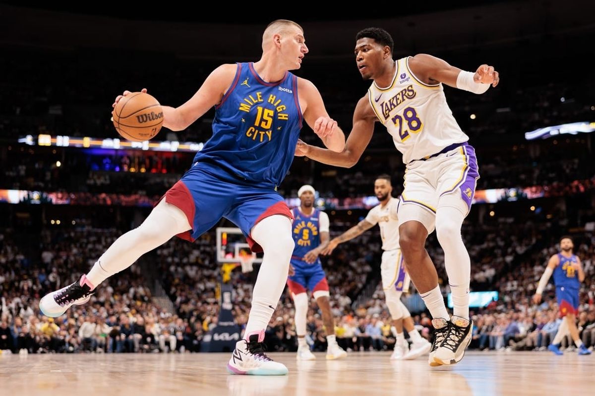 Apr 20, 2024; Denver, Colorado, USA; Denver Nuggets center Nikola Jokic (15) drives to the basket against Los Angeles Lakers forward Rui Hachimura (28) during the second quarter in game one of the first round for the 2024 NBA playoffs at Ball Arena.