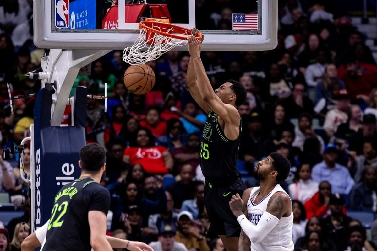 Mar 15, 2024; New Orleans, Louisiana, USA;  New Orleans Pelicans guard Trey Murphy III (25) dunks the ball against LA Clippers forward Paul George (13) during the second half at Smoothie King Center.