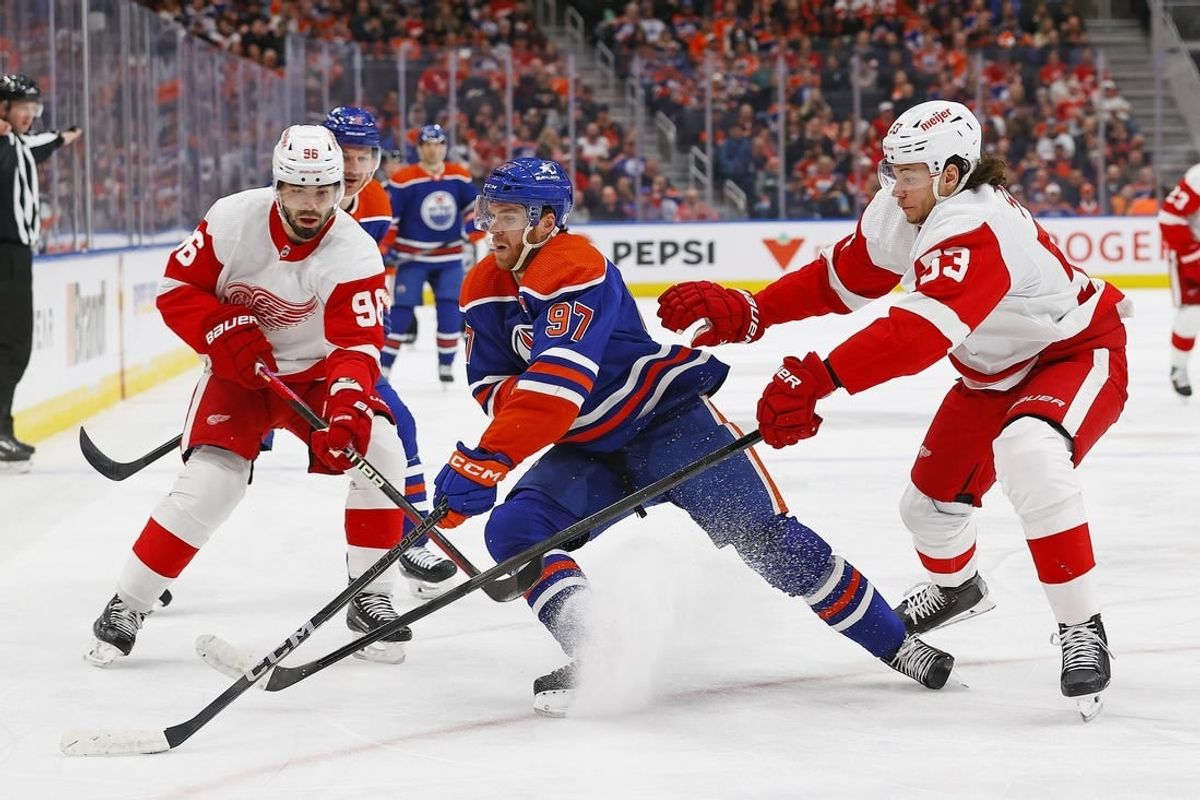 Feb 13, 2024; Edmonton, Alberta, CAN; Edmonton Oilers forward Connor McDavid (97) protects the puck from Detroit Red Wings defensemen Moritz Seider (53) and defensemen Jake Walman (96) at Rogers Place.
