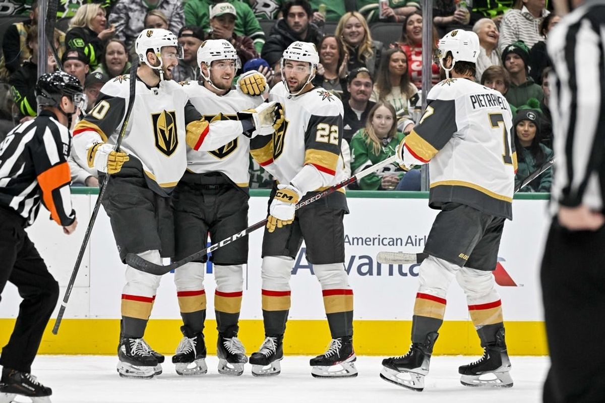 Nov 22, 2023; Dallas, Texas, USA; Vegas Golden Knights center Nicolas Roy (10) and right wing Michael Amadio (22) and center Ivan Barbashev (49) and defenseman Alex Pietrangelo (7) celebrates a goal scored by Amadio against the Dallas Stars during the first period at the American Airlines Center.