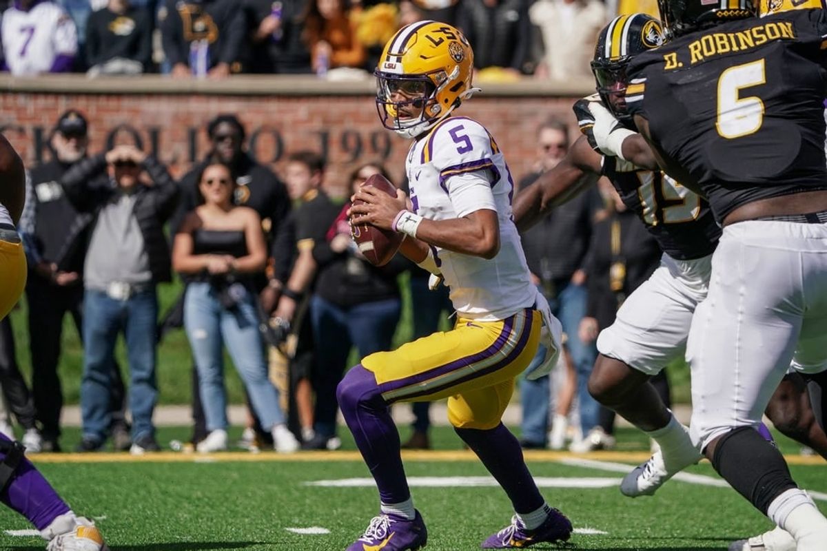 Oct 7, 2023; Columbia, Missouri, USA; LSU Tigers quarterback Jayden Daniels (5) drops back to pass against the Missouri Tigers during the first half at Faurot Field at Memorial Stadium.