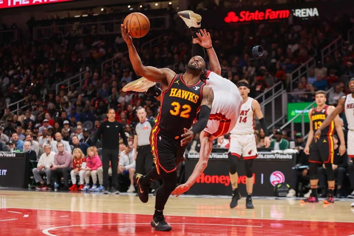 Apr 9, 2024; Atlanta, Georgia, USA; Atlanta Hawks guard Wesley Matthews (32) as Miami Heat forward Nikola Jovic (5) goes over his head in the second half at State Farm Arena.