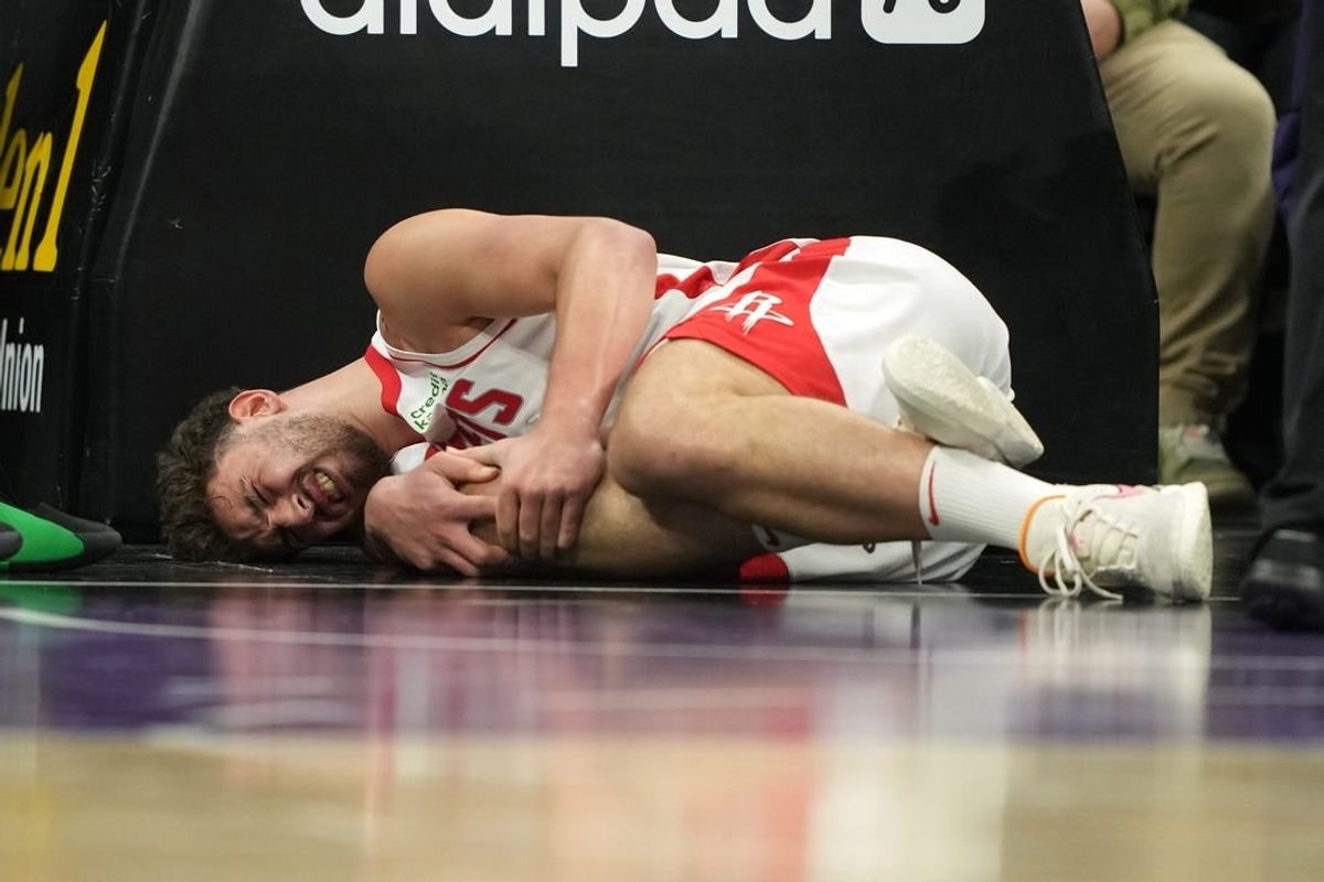 Mar 10, 2024; Sacramento, California, USA; Houston Rockets center Alperen Sengun (28) lies on the court after suffering an injury against the Sacramento Kings during the fourth quarter at Golden 1 Center.