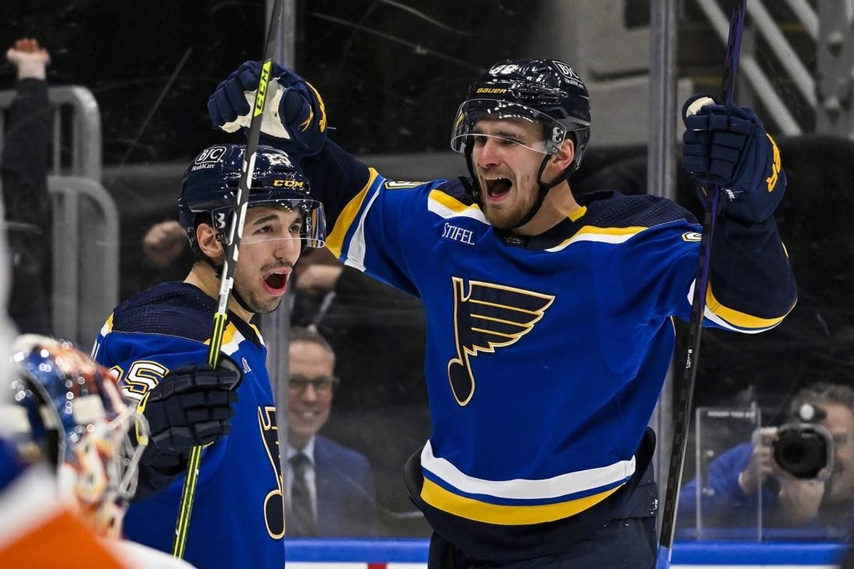 Feb 22, 2024; St. Louis, Missouri, USA;  St. Louis Blues left wing Pavel Buchnevich (89) celebrates with center Jordan Kyrou (25) after scoring his second goal of the game against New York Islanders goaltender Semyon Varlamov (40) during the second period at Enterprise Center.