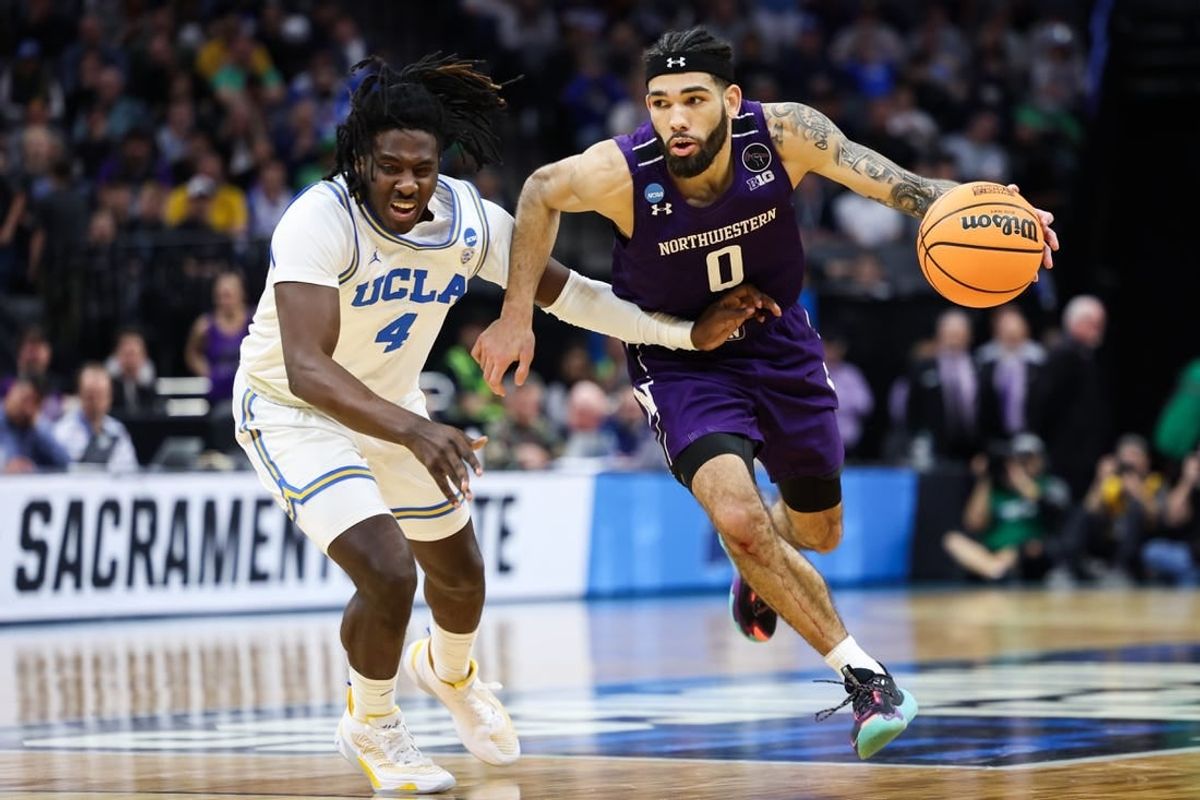 Mar 18, 2023; Sacramento, CA, USA; Northwestern Wildcats guard Boo Buie (0) drives to the basket while defended by UCLA Bruins guard Will McClendon (4) during the second half at Golden 1 Center.