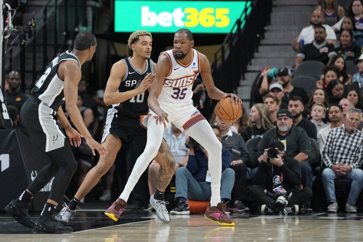 Mar 23, 2024; San Antonio, Texas, USA;  Phoenix Suns forward Kevin Durant (35) backs in against San Antonio Spurs forward Jeremy Sochan (10) in the first half at Frost Bank Center.