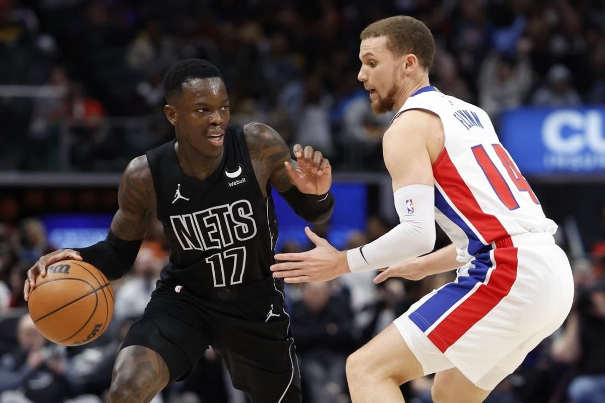 Mar 7, 2024; Detroit, Michigan, USA;  Brooklyn Nets guard Dennis Schroder (17) dribbles defended by Detroit Pistons guard Malachi Flynn (14) in the second half at Little Caesars Arena.