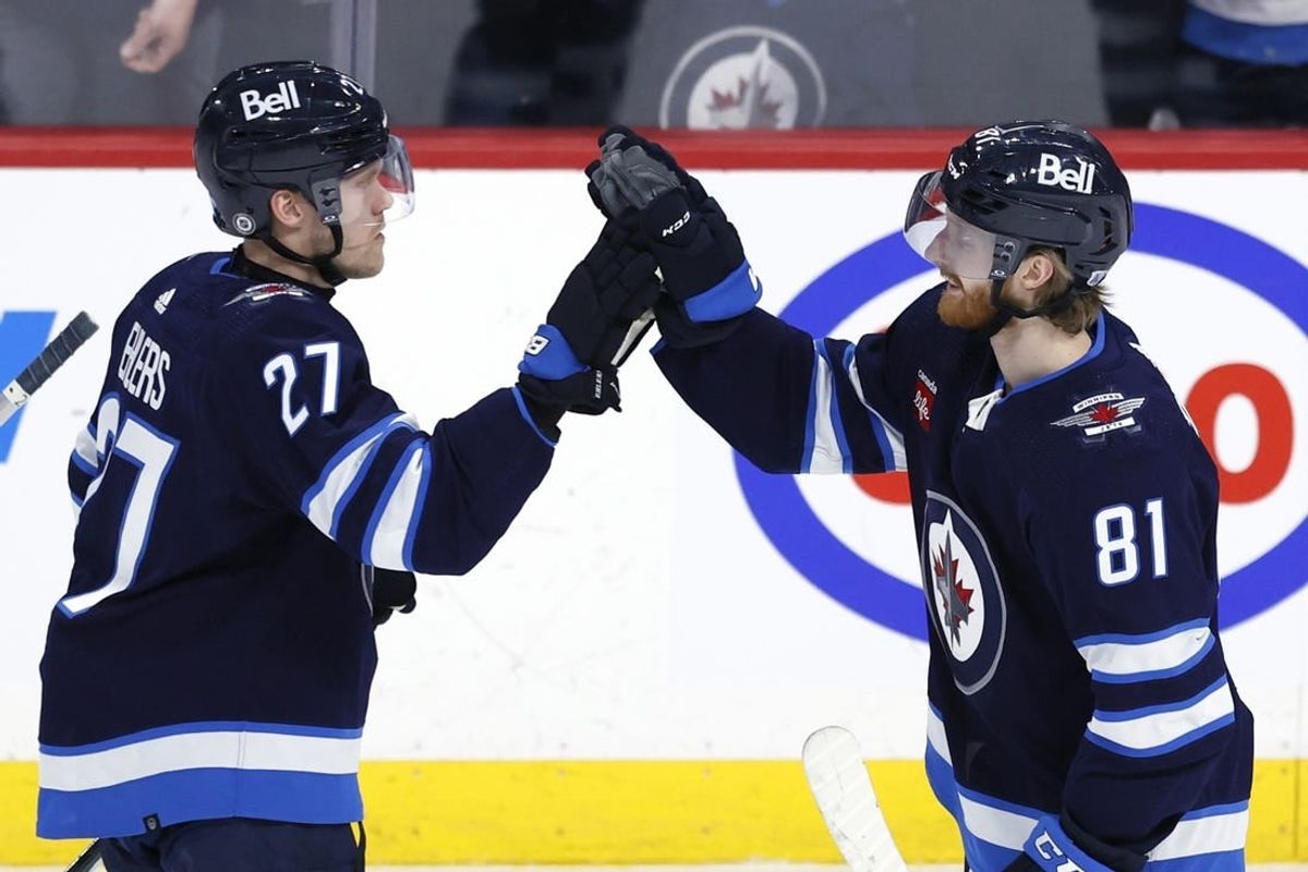 Feb 25, 2024; Winnipeg, Manitoba, CAN; \Winnipeg Jets left wing Kyle Connor (81) celebrates his overtime goal with Winnipeg Jets left wing Nikolaj Ehlers (27) against the Arizona Coyotes at Canada Life Centre.