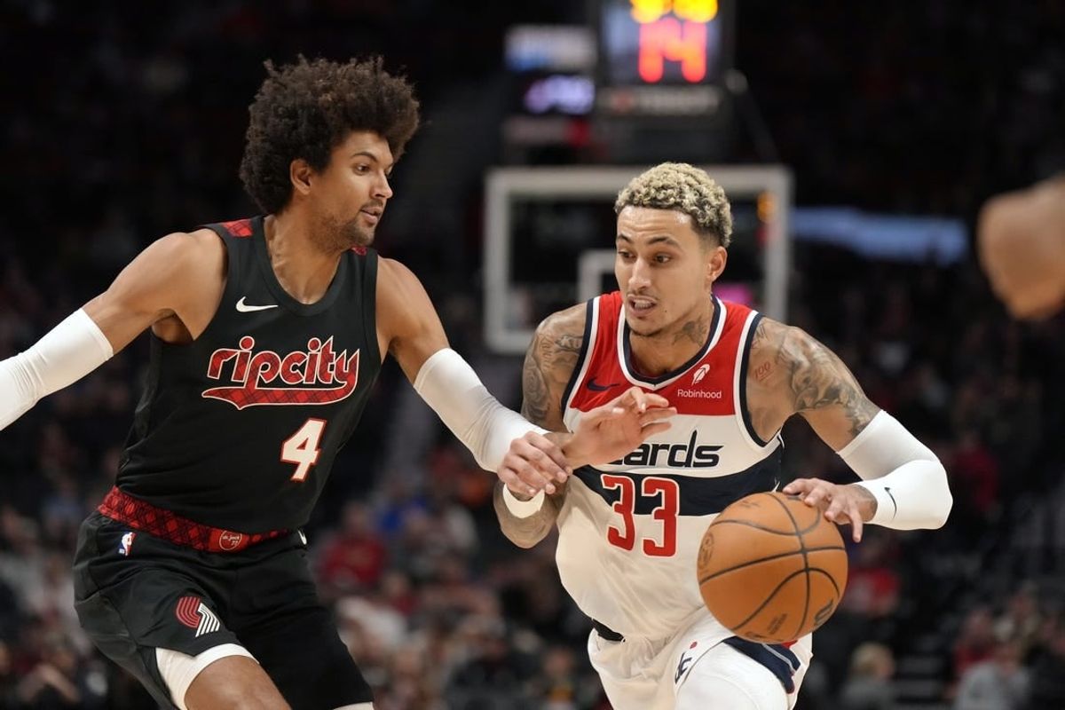 Dec 21, 2023; Portland, Oregon, USA; Washington Wizards small forward Kyle Kuzma (33) dribbles the ball as Portland Trail Blazers shooting guard Matisse Thybulle (4) defends during the first half at Moda Center.
