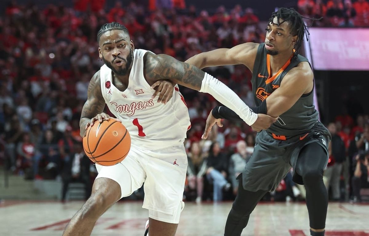 Feb 6, 2024; Houston, Texas, USA; Houston Cougars guard Jamal Shead (1) drives with the ball as Oklahoma State Cowboys guard Jarius Hicklen (4) defends during the second half at Fertitta Center.