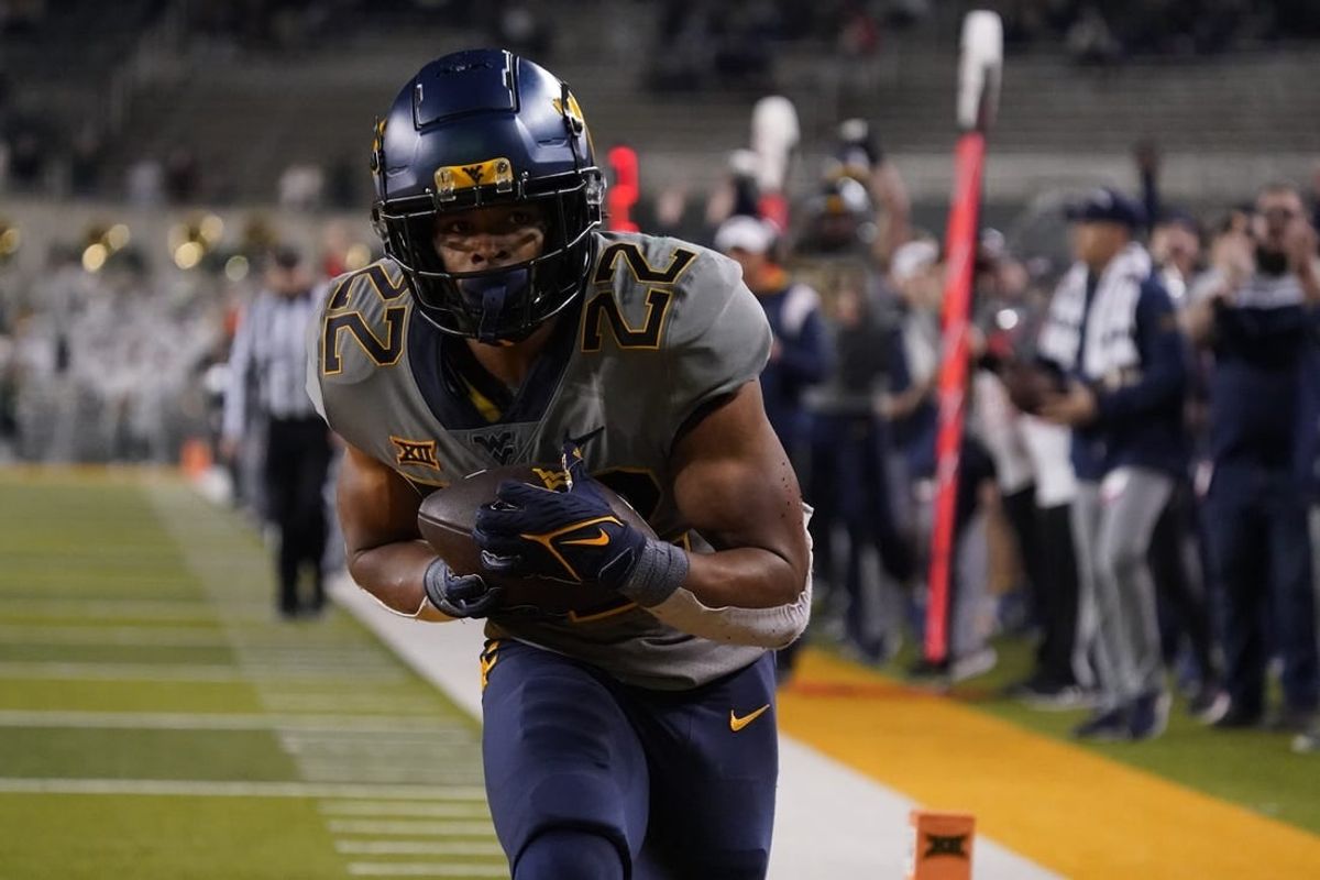 Nov 25, 2023; Waco, Texas, USA; West Virginia Mountaineers running back Jahiem White (22) makes the game winning 29-yard touchdown catch against the Baylor Bears during the second half at McLane Stadium.