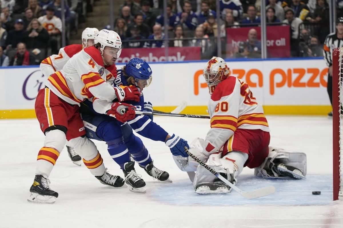 Nov 10, 2023; Toronto, Ontario, CAN; Toronto Maple Leafs forward William Nylander (88) scores against Calgary Flames goaltender Dan Vladar (80) and defenseman Rasmus Andersson (4) during the first period at Scotiabank Arena.