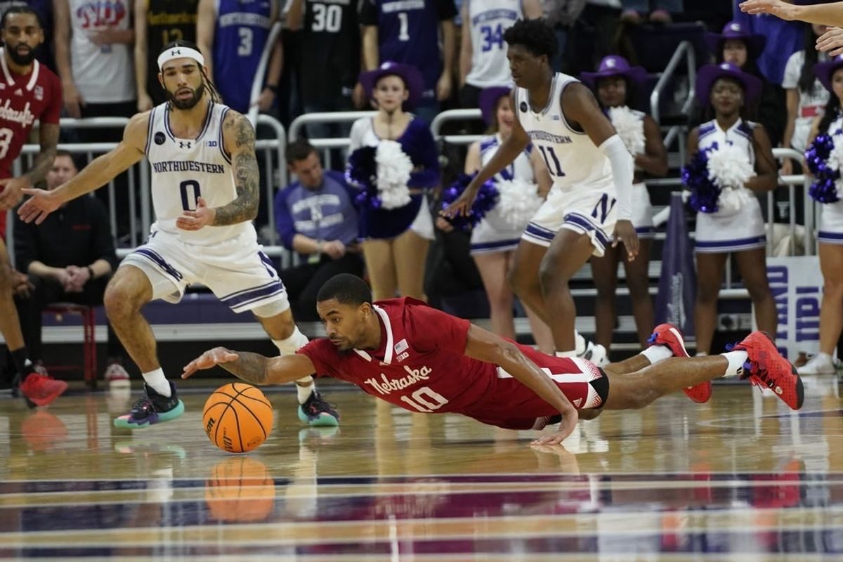 Feb 7, 2024; Evanston, Illinois, USA; Nebraska Cornhuskers guard Jamarques Lawrence (10) dives for a loose ball against the Northwestern Wildcats during the second half at Welsh-Ryan Arena.