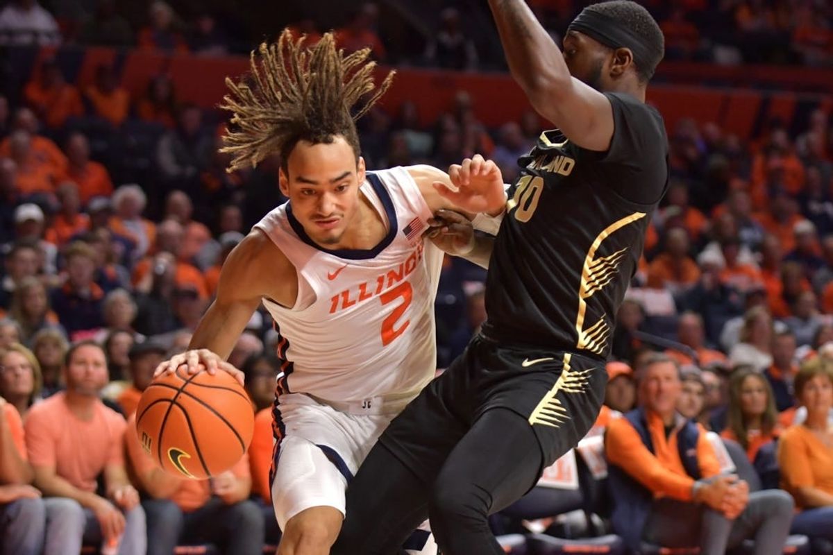 Nov 10, 2023; Champaign, Illinois, USA;  Illinois Fighting Illini guard Dra Gibbs-Lawhorn (2) drives against Oakland Golden Grizzlies guard DQ Cole (10) during the first half at State Farm Center.