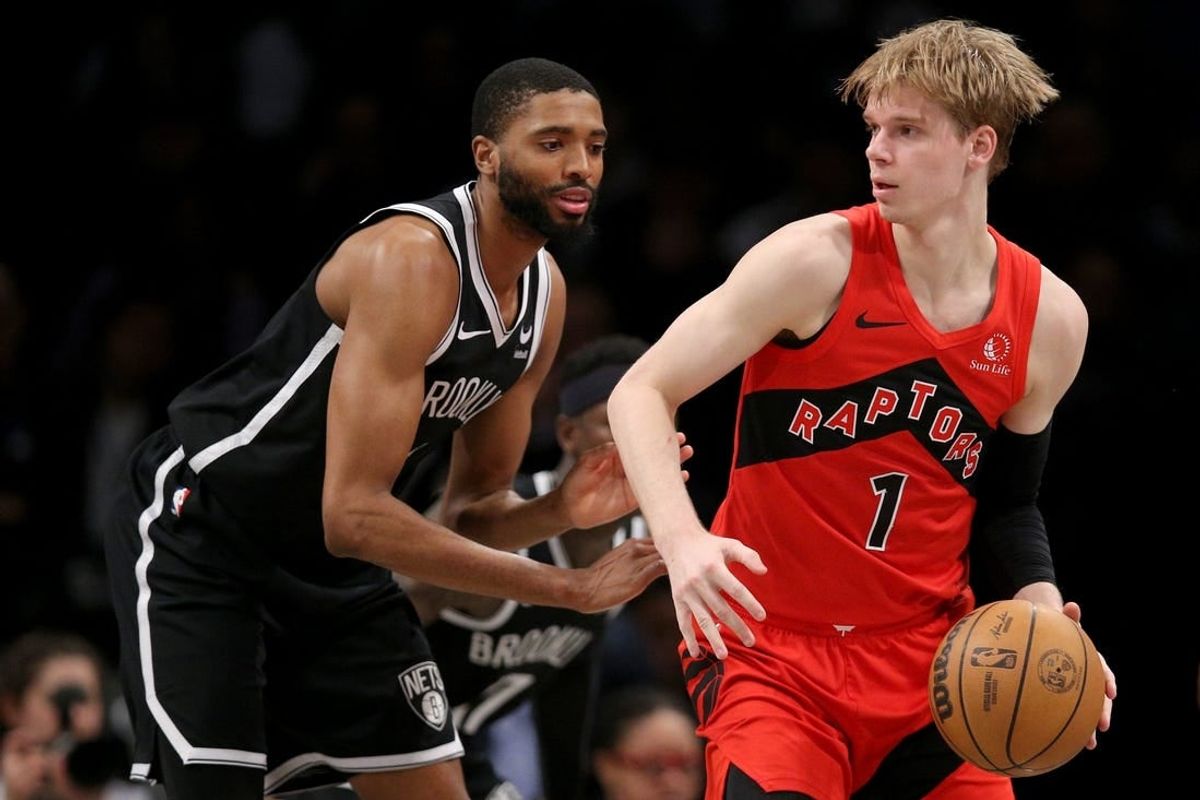 Apr 10, 2024; Brooklyn, New York, USA; Toronto Raptors guard Gradey Dick (1) controls the ball against Brooklyn Nets forward Mikal Bridges (1) during the second quarter at Barclays Center.