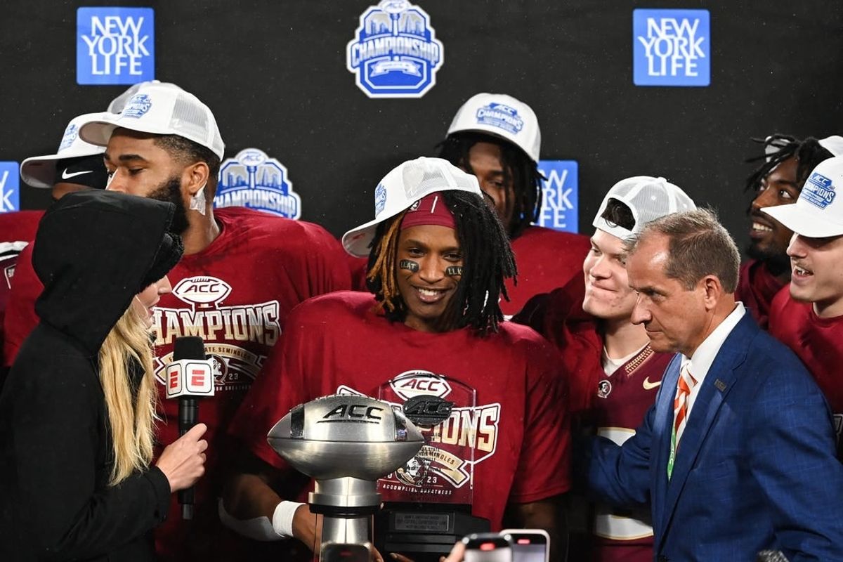 Dec 2, 2023; Charlotte, NC, USA; Florida State Seminoles running back Lawrance Toafili (9) is awarded the ACC Championship MVP trophy after the game against the Louisville Cardinals at Bank of America Stadium.